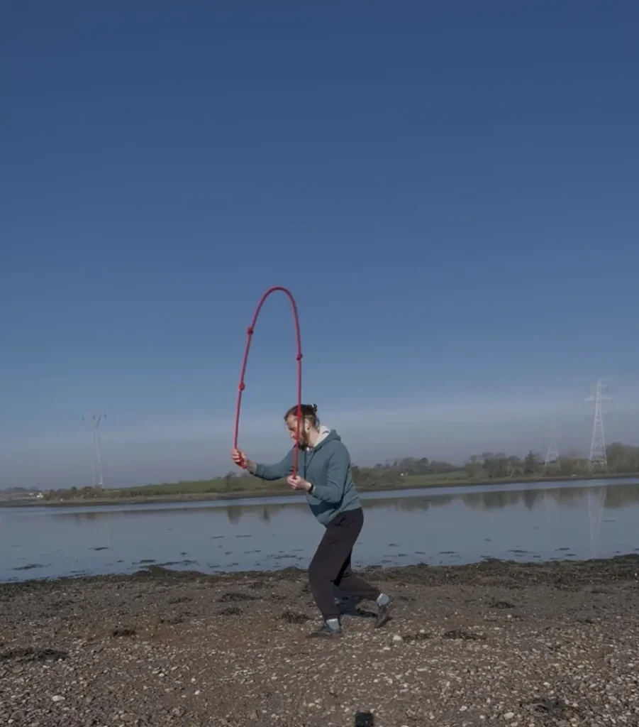 Ian practising rope flow beside the water